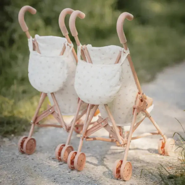 Two Little Dutch metal doll strollers with storage bags, perfect for imaginative adventures with dolls or soft toys.