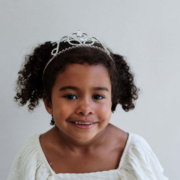 Little girl smiling in a Classic Princess Tiara by Mimi & Lula, perfect for special occasions.