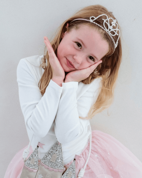 Little girl wearing the Mimi & Lula, Classic Princess Tiara, smiling and posing in a party outfit.
