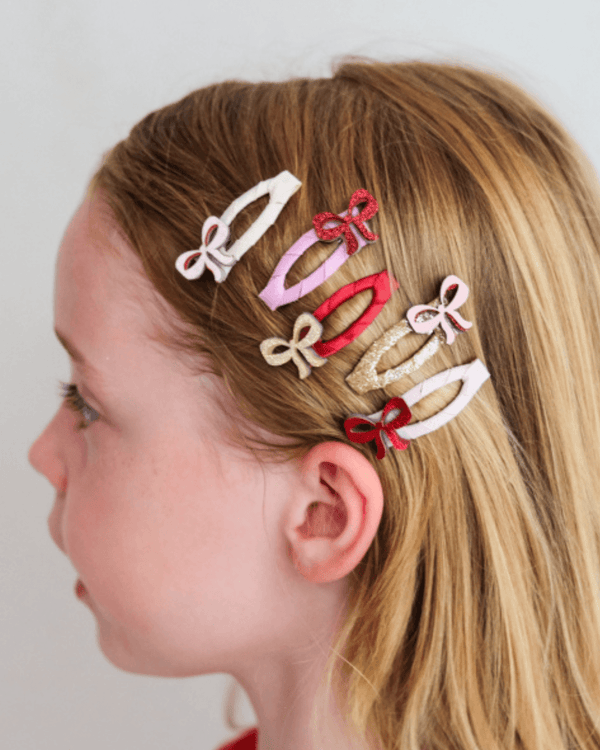 Mimi & Lula, Cutesy Bow Mini Hair Clips in vibrant colors worn by a girl, perfect for any outfit!