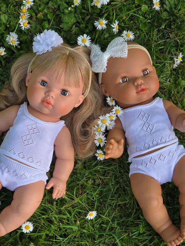 Dolls Vest and Pants Set in White on two 34cm dolls surrounded by daisies, showcasing the cute underwear set.