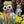 Child in flower crown and oversized sunglasses holding Gideon Grasshopper doll among blooming daffodils.