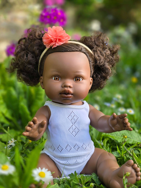 Dolls Vest and Pants Set in White displayed on Mini Colettos doll in floral garden.