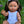 Mini Colettos, Isabel (Hispanic Girl, Brown Straight Hair and Blue Eyes) doll in a blue outfit, with brown hair and blue flower headband.