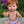 Mini Colettos, Jasper (Boy Doll with Brown Eyes & Red Hair) sitting outdoors with a cheerful expression.