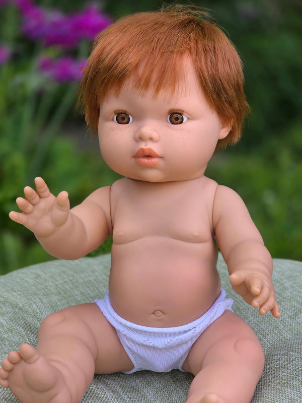 Mini Colettos, Jasper (Boy Doll with Brown Eyes & Red Hair) sitting with a cheerful expression and moveable limbs.