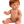 Mini Colettos, Jasper (Boy Doll with Brown Eyes & Red Hair) sitting in a playful pose with red hair and brown eyes.