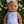 Dolls Vest and Pants Set in White displayed on a doll lying in flowers, highlighting the cute 2 piece design.