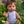 Dolls Vest and Pants Set in White displayed on a Mini Colettos doll sitting in a flower-filled garden.