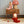 Two Dozy Dinkum dolls, Toadstool Pip and a companion, on a wicker table with a whimsical mushroom lamp.