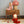 Cozy nursery scene featuring Olli Ella's Toadstool Lamp in Musk, with adorable dolls and wooden blocks.