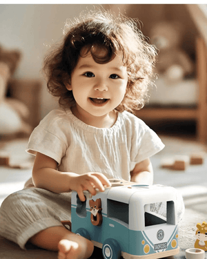 Happy toddler playing with Speedy Monkey, Shape Sorter Van, encouraging early learning and imaginative play.