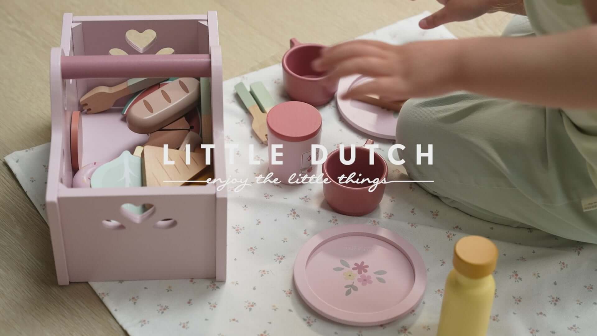 Little Dutch pink picnic set with wooden utensils and bowls for imaginative play on a picnic blanket.